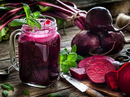 Red beet pink beverages with raw ingredients on table