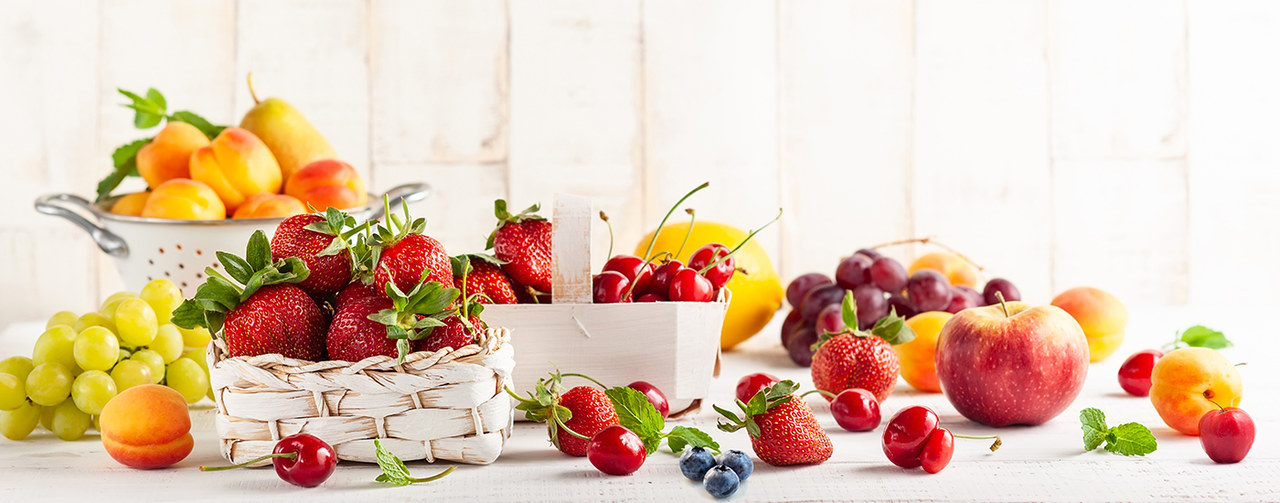 Fruits on wooden table - Berries, apple, peach, pear acerola, grappe