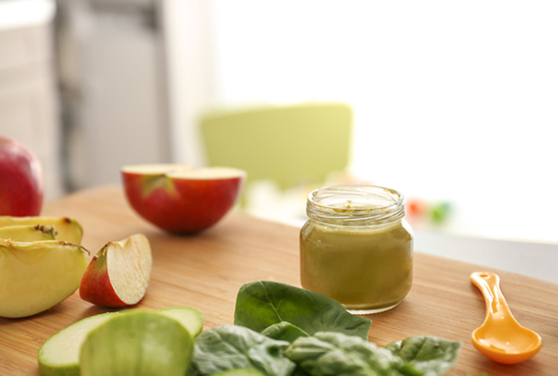 fruit and vegetables ingredients for baby food on kitchen table