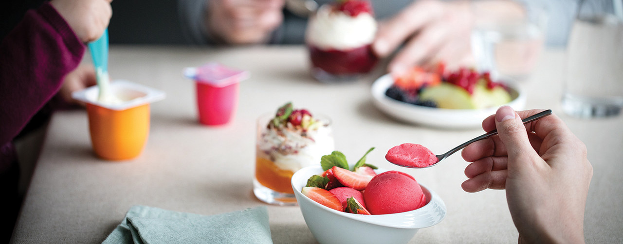 Family eating yogurt, ice creams and desserts 