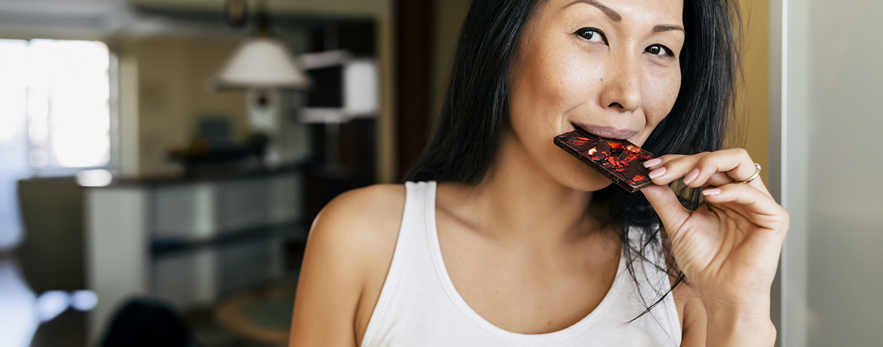 Asian woman enjoying chocolate at home