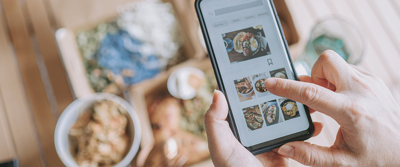 Close up woman using online app on smartphone for personalized food at home