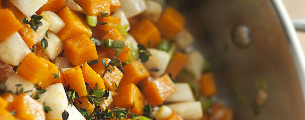 Culinary preparations with herbs and vegetables in a saucepan