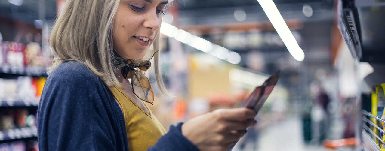 Woman shopping in a supermarket looking for new products