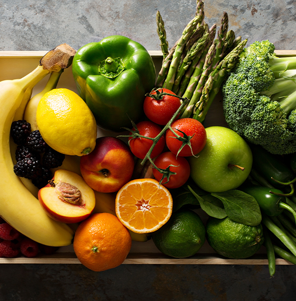 Top view of a wooden crate filled with fruits and vegetables