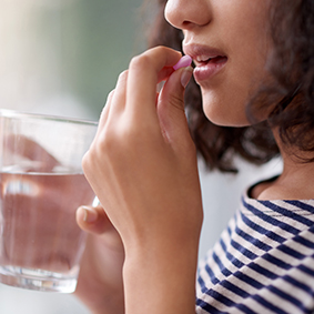 Woman taking pill