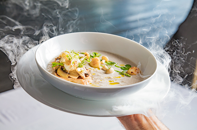 Cream mushroom soup with scallops, herbs, toast bread and dried ice mist