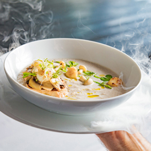 Cream mushroom soup with scallops, herbs, toast bread and dried ice mist