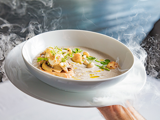 Cream mushroom soup with scallops, herbs, toast bread and dried ice mist