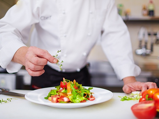 Chef adding his final touch to his gourmet dish