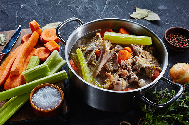 Cooked chicken stock with vegetables and aromatic herbs - Mirepoix