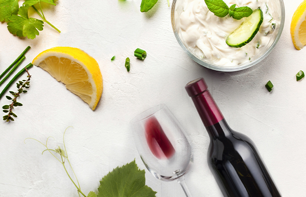 Top view of sauces with lemon and wines on white table