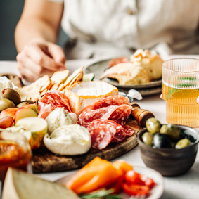 Woman eating processed meat and antipasti