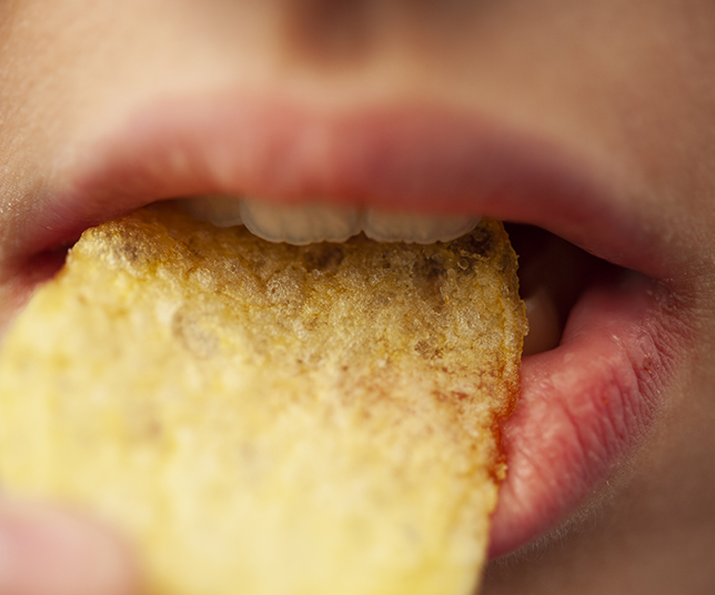 Close up mouth eating snack