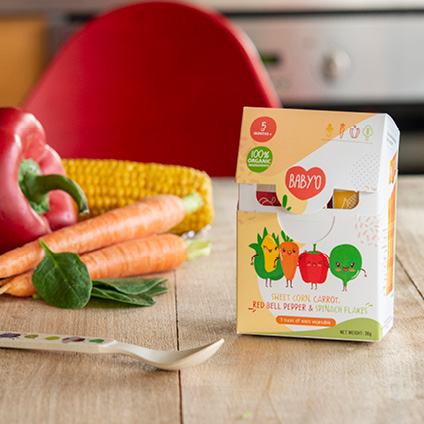 Baby food infant cereals with vegetables on wooden table