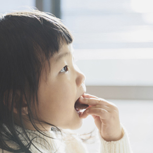 Baby girl eating toddler snack