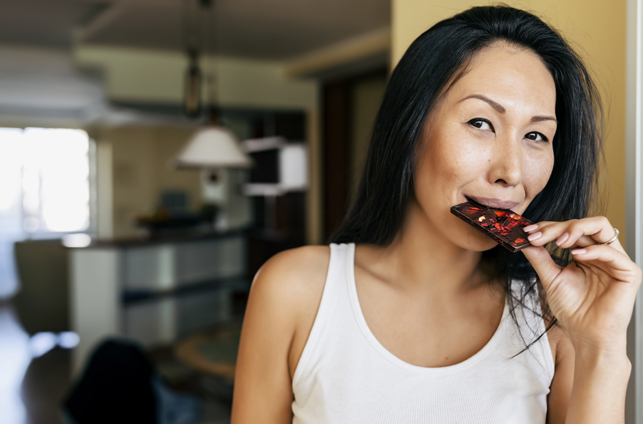 Asian woman enjoying chocolate at home