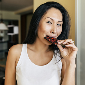 Asian woman enjoying chocolate at home