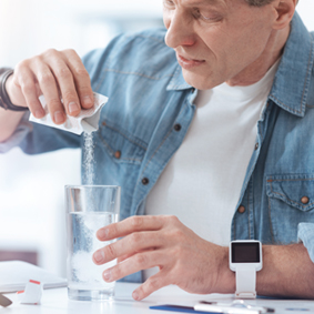 Senior man taking pharmaceutical powder 