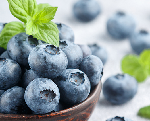 Fresh blueberries in a wooden bowl