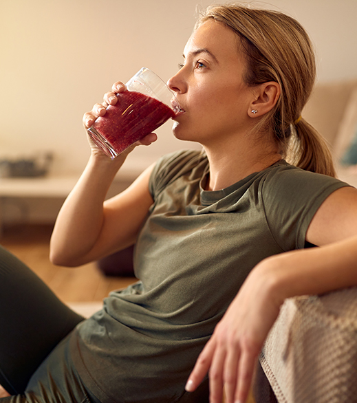 woman drinking health drink with aronia