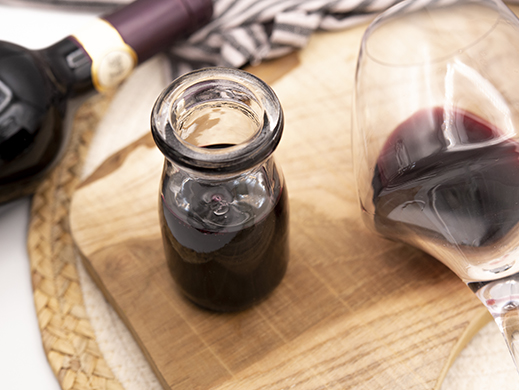 Red wine concentrate and glass on table