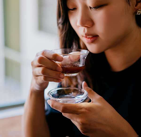 Asian woman drinking prune juice concentrate