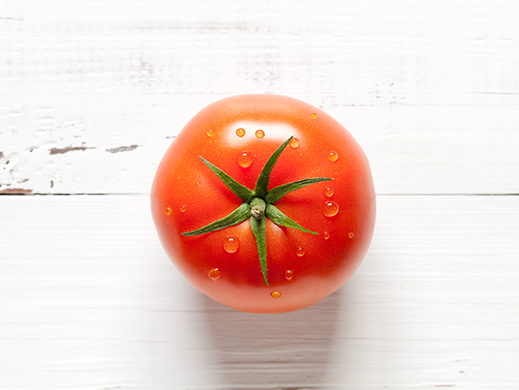 Top view of fresh tomato on white wooden table