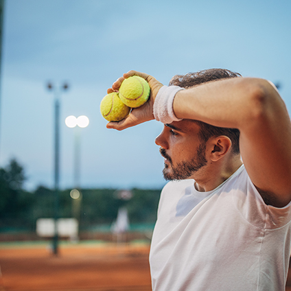 tennis player on tennis court, playing a match