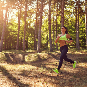 Sportive woman running in nature