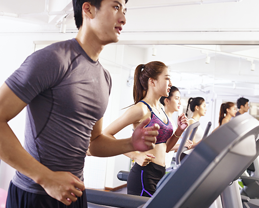 Asian young people exercising on running track