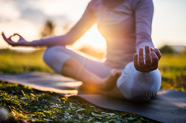 Close up of meditation woman in park at sunrise