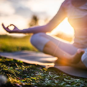 Close up of meditation woman in park at sunrise