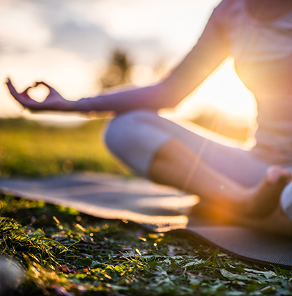 Close up of meditation woman in park at sunrise