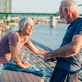 Senior couple stretching outdoors